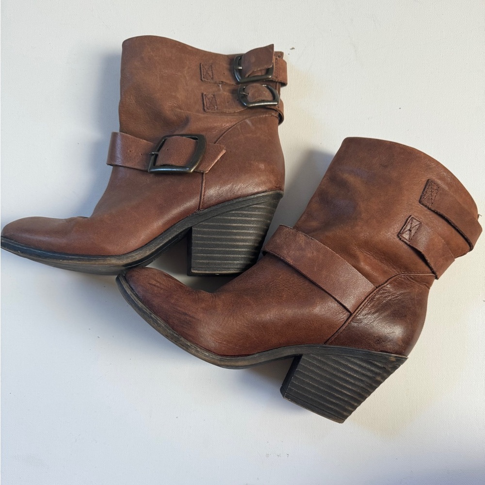 Brown leather boho healed boots with buckles.